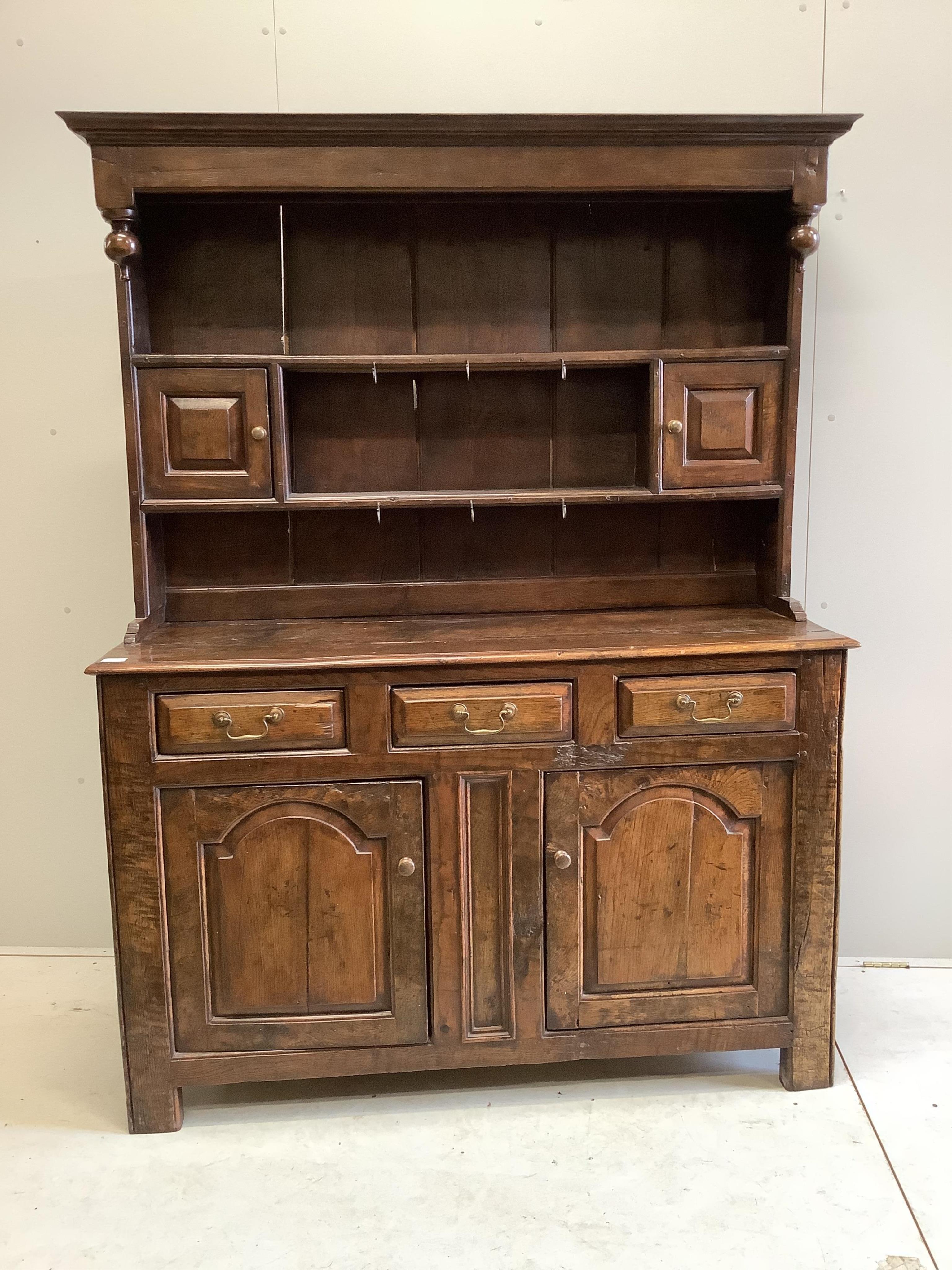 An early 18th century oak dresser, width 142cm, depth 52cm, height 188cm. Condition - fair